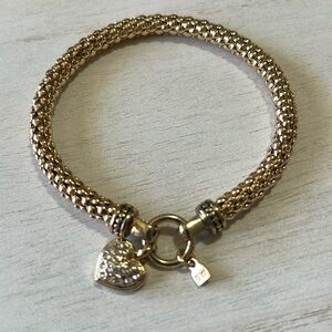 Nine West shiny gold tone bracelet with heart charm